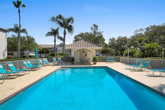 pool featuring a patio area and fence