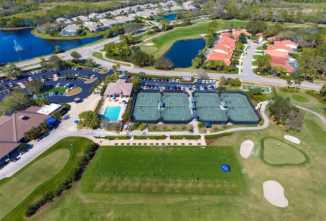 drone / aerial view with a water view and view of golf course