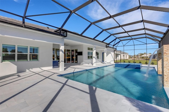 outdoor pool with a lanai, a ceiling fan, and a patio area