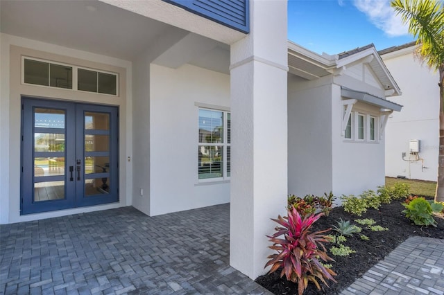 doorway to property with french doors and stucco siding