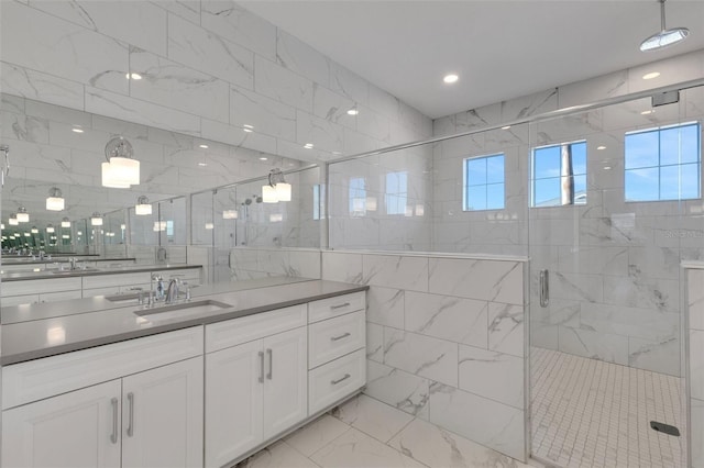 bathroom with vanity, recessed lighting, a stall shower, marble finish floor, and tile walls