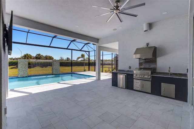 outdoor pool featuring grilling area, glass enclosure, exterior kitchen, ceiling fan, and a patio area