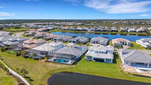 drone / aerial view with a residential view and a water view