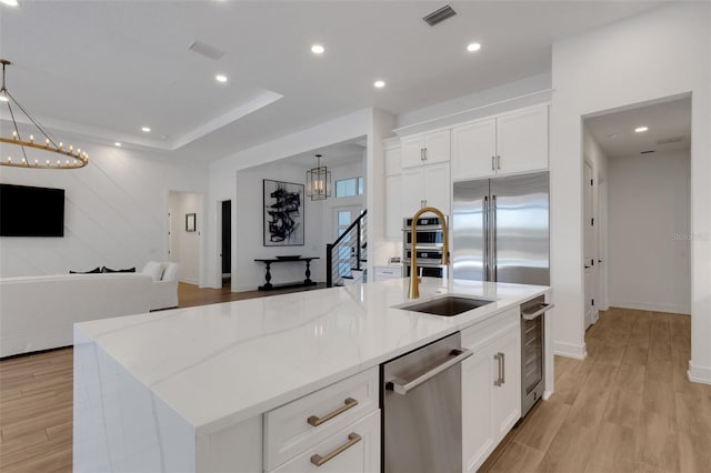 kitchen featuring beverage cooler, visible vents, appliances with stainless steel finishes, a notable chandelier, and open floor plan