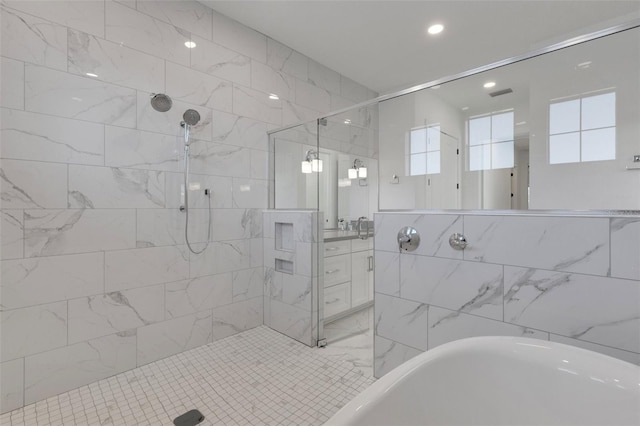 bathroom featuring a freestanding tub, visible vents, tile walls, tiled shower, and vanity