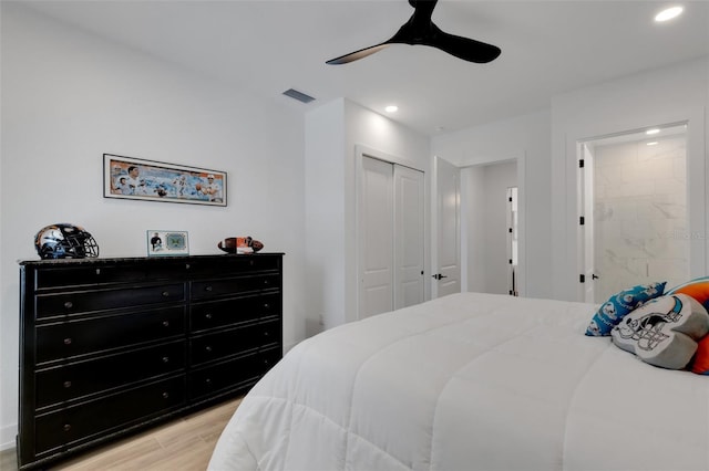 bedroom with visible vents, light wood-style flooring, recessed lighting, and a closet