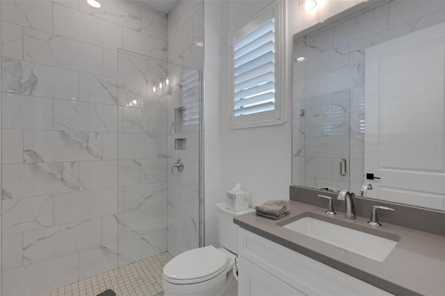 bathroom with vanity, toilet, and a shower stall