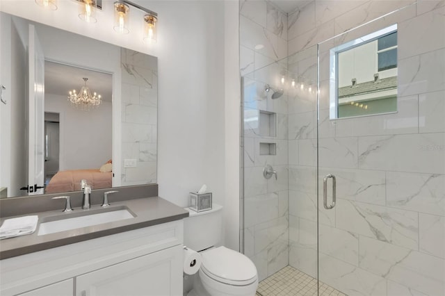 bathroom featuring toilet, ensuite bathroom, a shower stall, a chandelier, and vanity