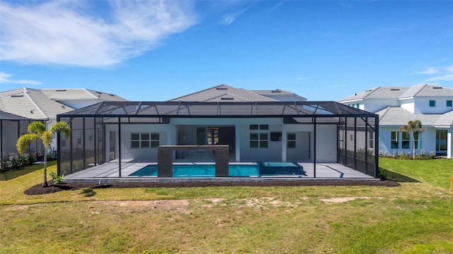 rear view of property featuring glass enclosure, an outdoor pool, a patio area, and a lawn