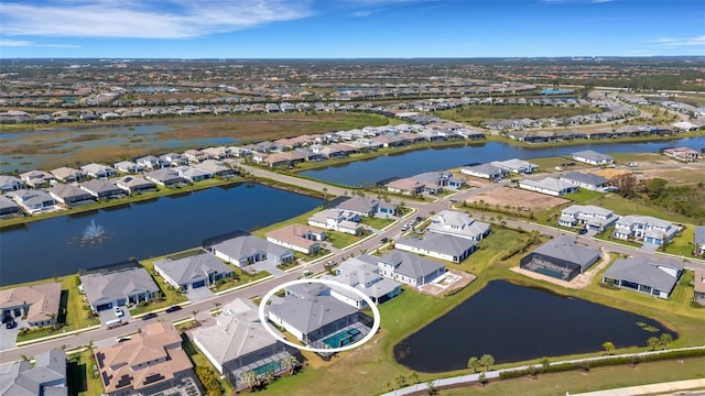 birds eye view of property featuring a residential view and a water view