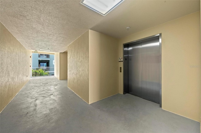 property entrance featuring stucco siding and elevator