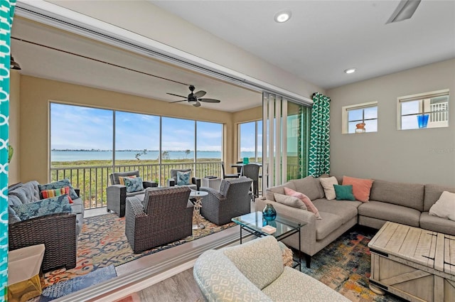 living room with recessed lighting, wood finished floors, a wealth of natural light, and ceiling fan