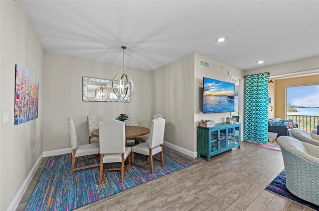 dining room featuring visible vents, wood finished floors, recessed lighting, an inviting chandelier, and baseboards