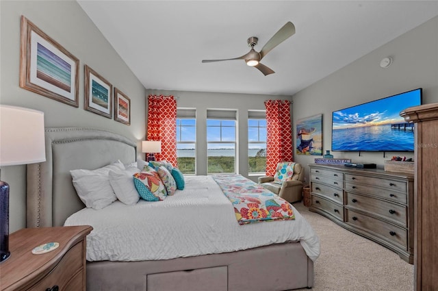 bedroom featuring light colored carpet and ceiling fan