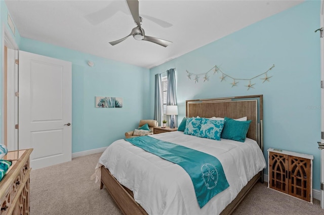 carpeted bedroom with baseboards and ceiling fan