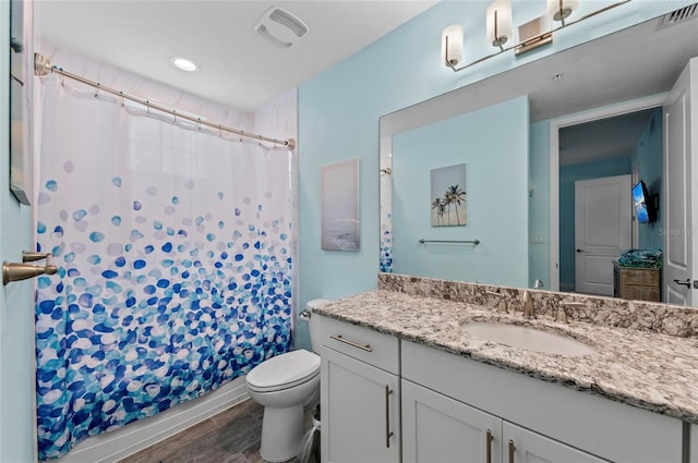 full bathroom with visible vents, toilet, vanity, and wood finished floors