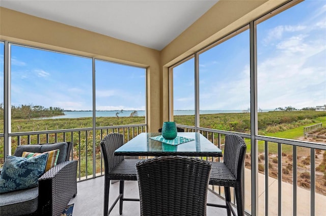 sunroom / solarium with a water view