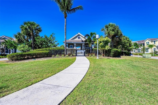 view of front facade featuring a front yard and fence