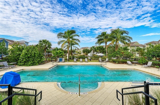 community pool featuring a patio and fence