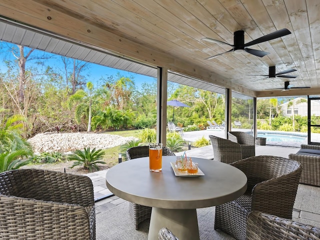 exterior space featuring wooden ceiling and a ceiling fan