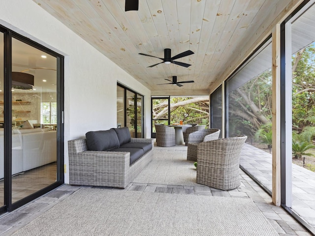 sunroom / solarium with wooden ceiling and a ceiling fan