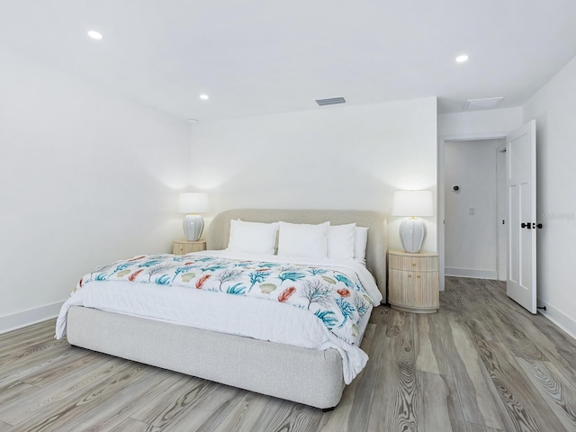 bedroom featuring recessed lighting, visible vents, baseboards, and wood finished floors