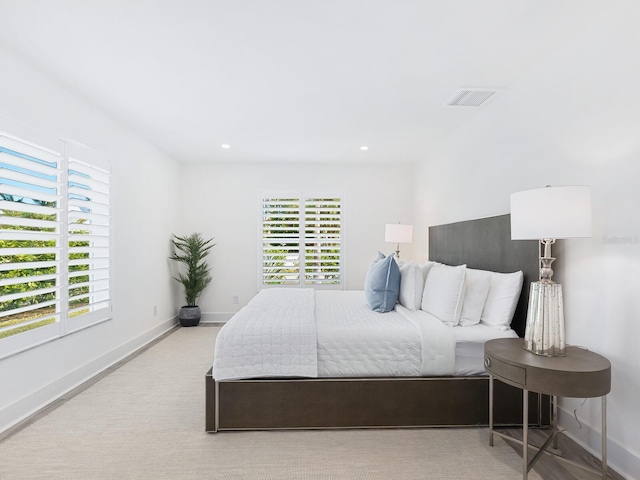 bedroom with baseboards, multiple windows, and visible vents