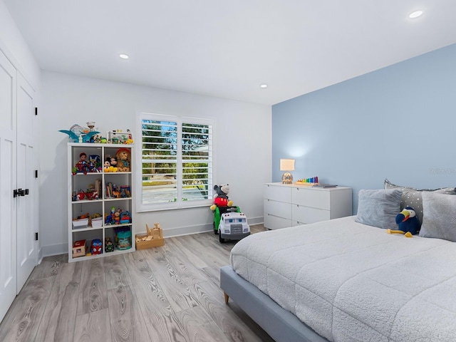 bedroom with recessed lighting, baseboards, and wood finished floors