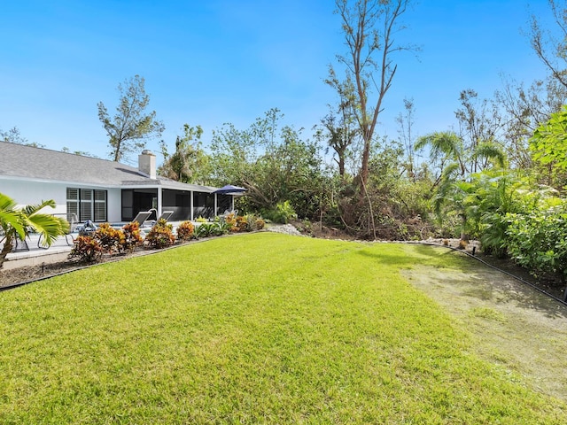 view of yard with a sunroom