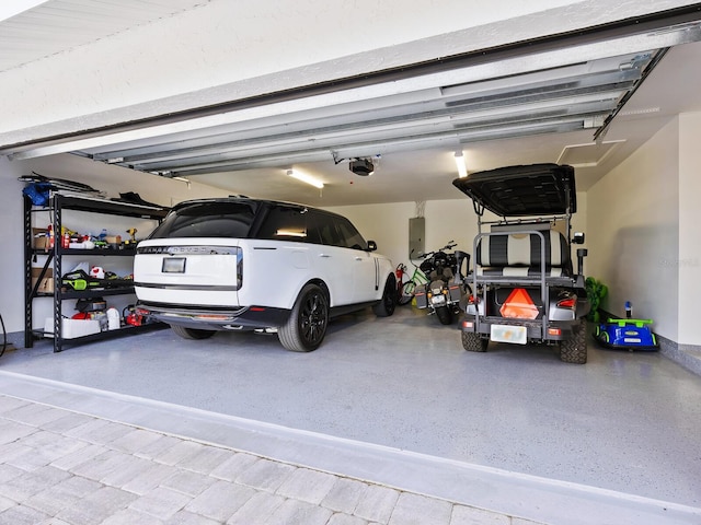 garage with electric panel and a garage door opener