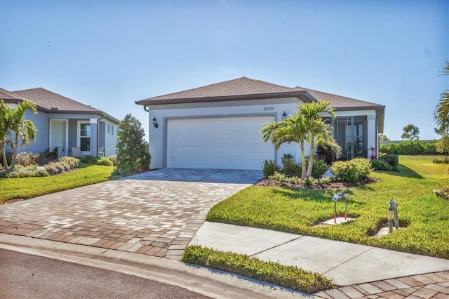 view of front of house featuring a garage, stucco siding, driveway, and a front lawn