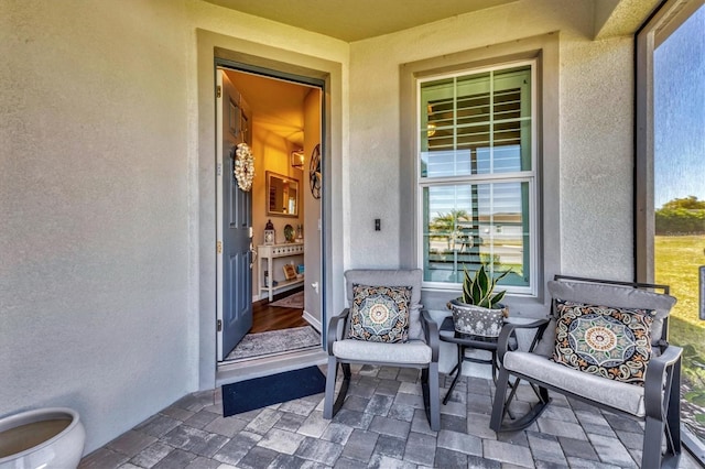 doorway to property with stucco siding