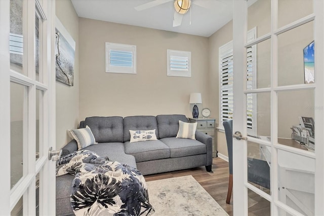 living room featuring a ceiling fan, wood finished floors, and french doors