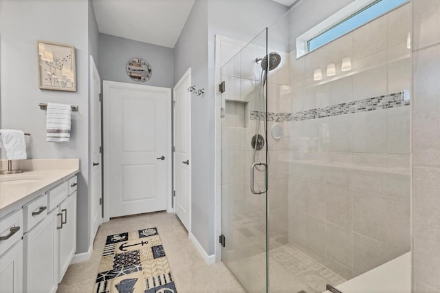 bathroom with baseboards, a stall shower, and vanity