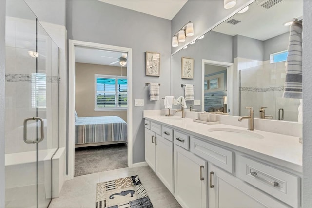 full bath with visible vents, double vanity, a stall shower, a sink, and ensuite bathroom