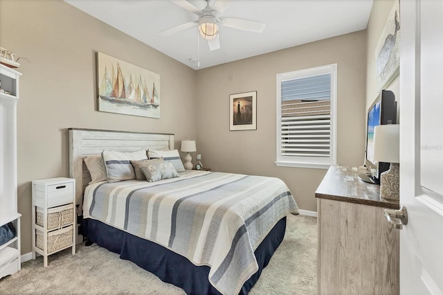 bedroom with light carpet, a ceiling fan, and baseboards