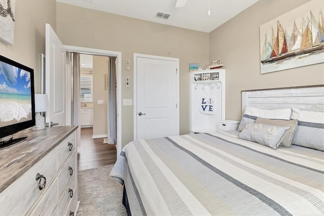 carpeted bedroom with visible vents and a ceiling fan