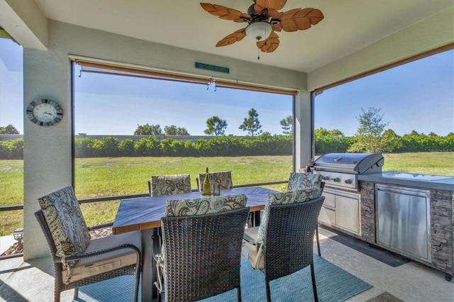 view of patio featuring area for grilling, a grill, outdoor dining area, and a ceiling fan