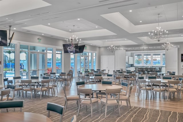 dining space featuring visible vents, a tray ceiling, recessed lighting, a towering ceiling, and a notable chandelier