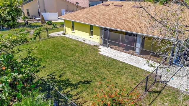 rear view of property featuring a patio, a gate, fence, stucco siding, and a lawn