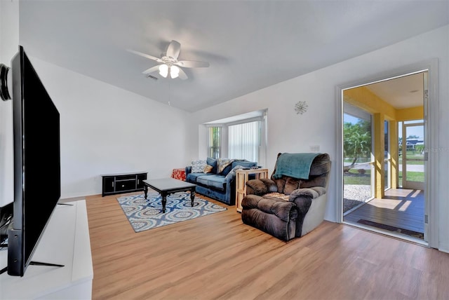 living room with visible vents, wood finished floors, lofted ceiling, and ceiling fan