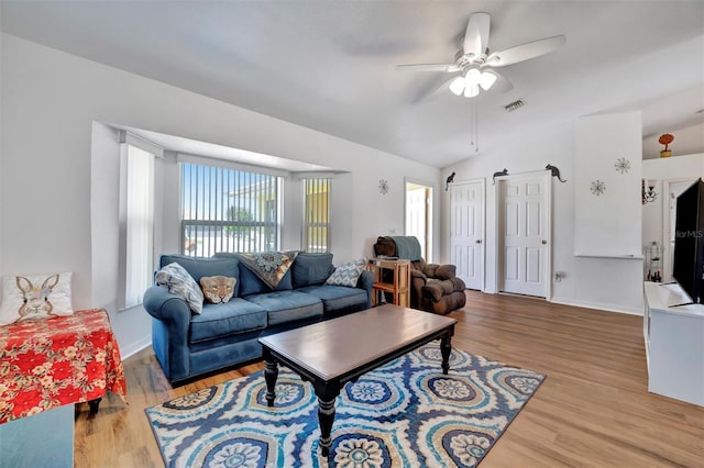 living area featuring wood finished floors, baseboards, visible vents, lofted ceiling, and ceiling fan