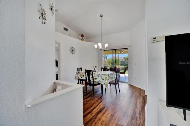 dining space featuring a chandelier, visible vents, wood finished floors, and vaulted ceiling