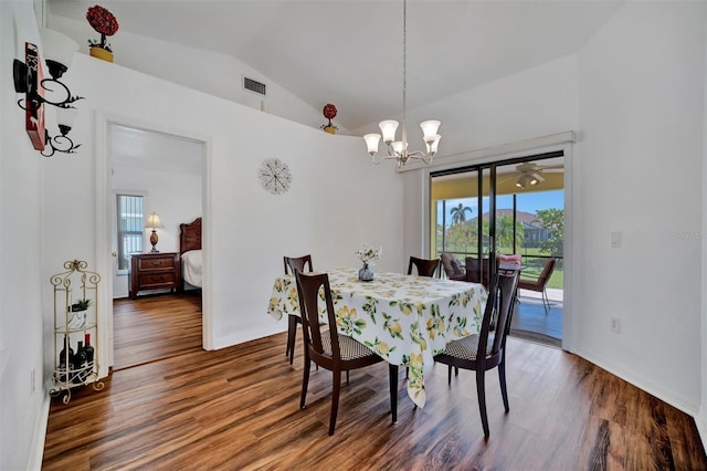 dining space with visible vents, an inviting chandelier, lofted ceiling, and wood finished floors