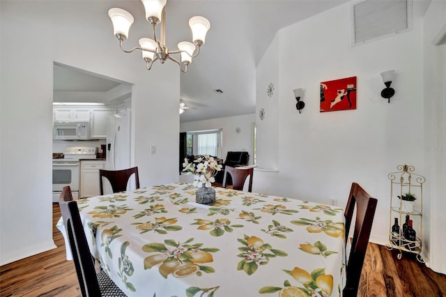 dining room with wood finished floors, visible vents, and a chandelier