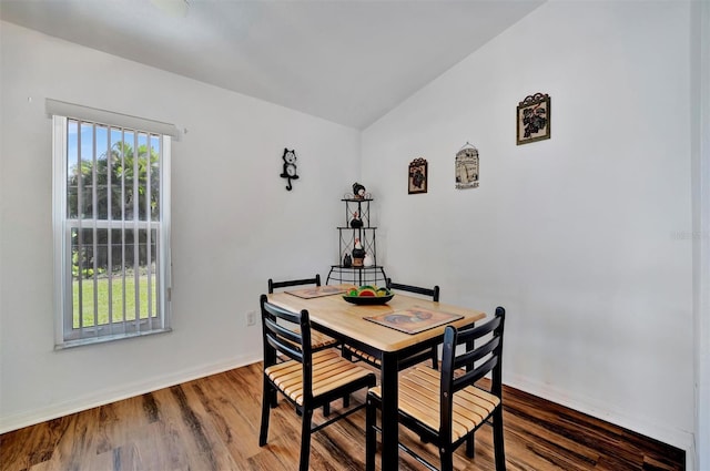 dining space with wood finished floors and baseboards