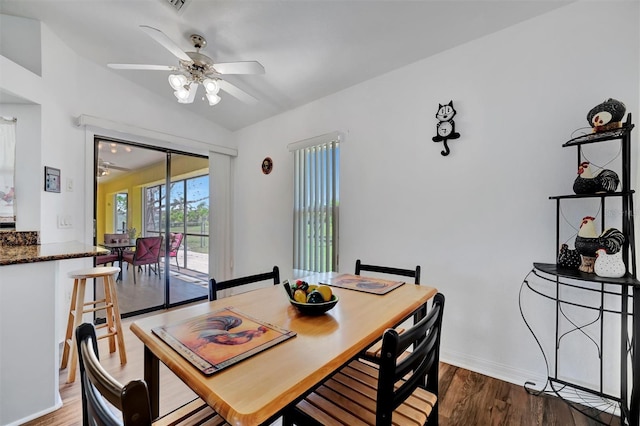 dining area featuring vaulted ceiling, wood finished floors, baseboards, and ceiling fan