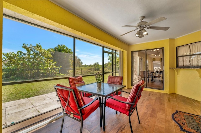 sunroom with a ceiling fan