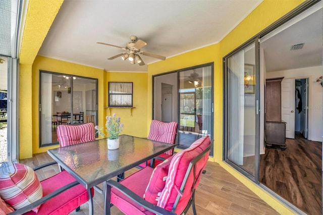 sunroom featuring visible vents and ceiling fan