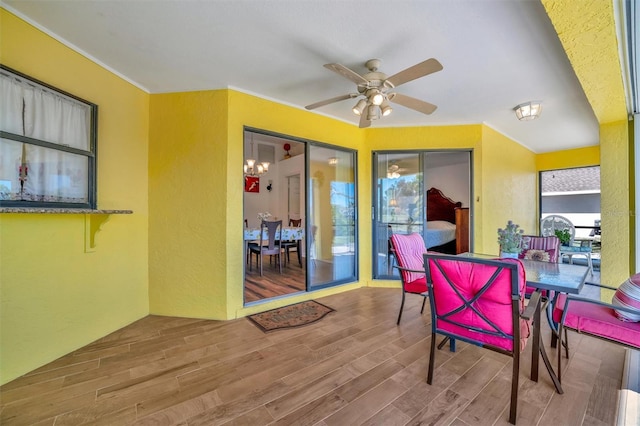 sunroom / solarium featuring a ceiling fan